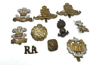 selection of military cap badges etc