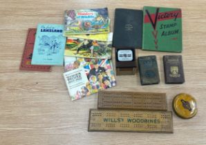 Two cribbage scoring boards and a vintage road atlas, vintage stamp collection, two vintage