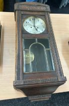 Oak Edwardian wall clock overall length 32 inches