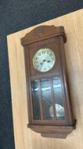 Oak Edwardian wall clock overall length 32 inches