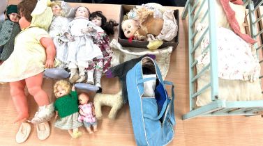 Selection of vintage dolls various sizes to include a vintage wooden dolls cot, additional clothing