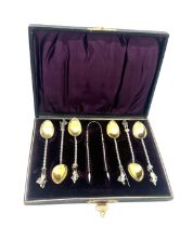 An unusual cased set of six silver spoons and sugar tongs. 830 grade. Bowls marked H.W cast