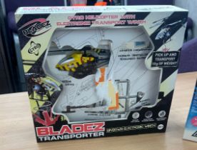 Two remote control helicopters one ' Bladez transporter gyro helicopter' the other a 'PicooZ