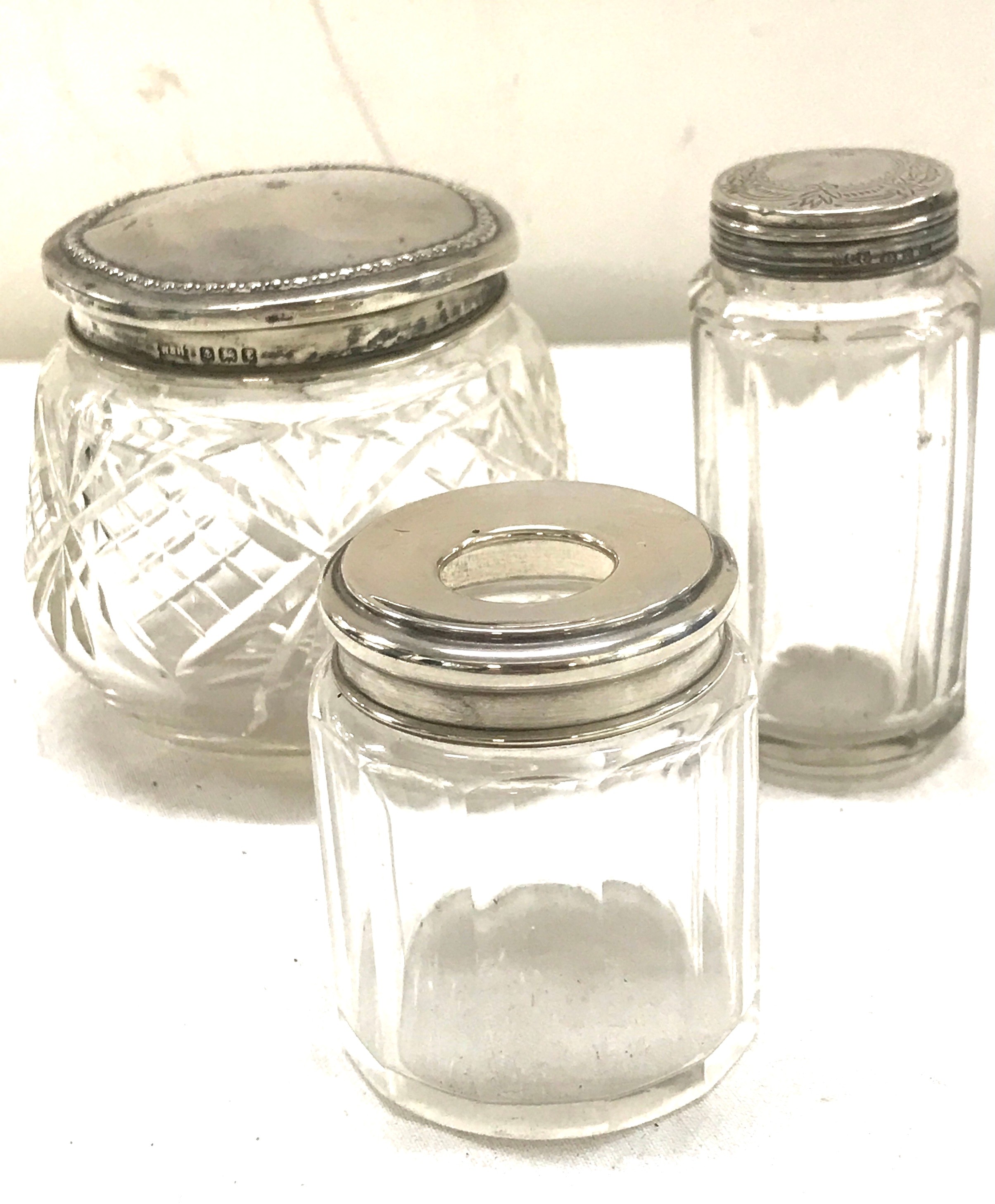 3 Hallmarked silver topped perfume jars