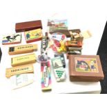 Box of toys and games includes tin automatic telephone, card games and play mobile