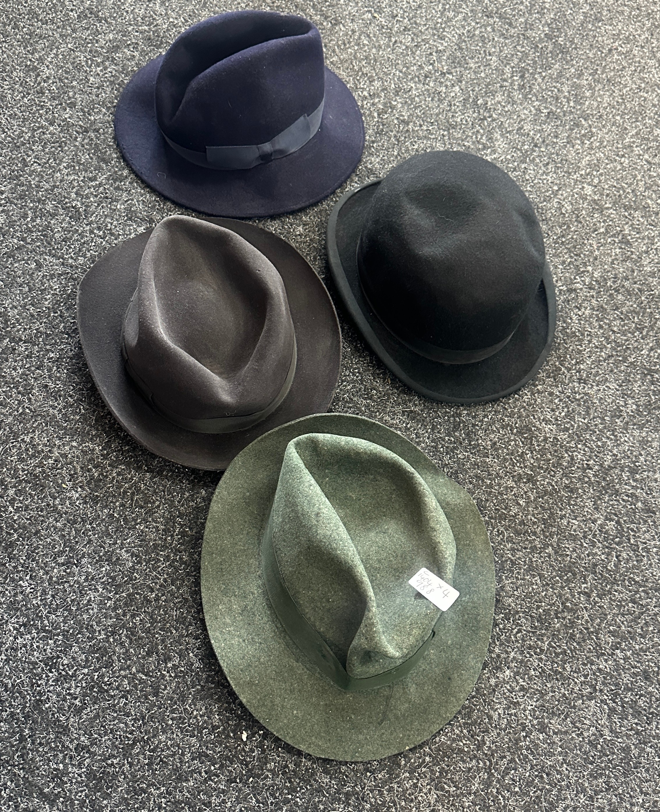 Four top hats to include the names ' Earl land Brothers', 'Wood row Piccadilly London' etc