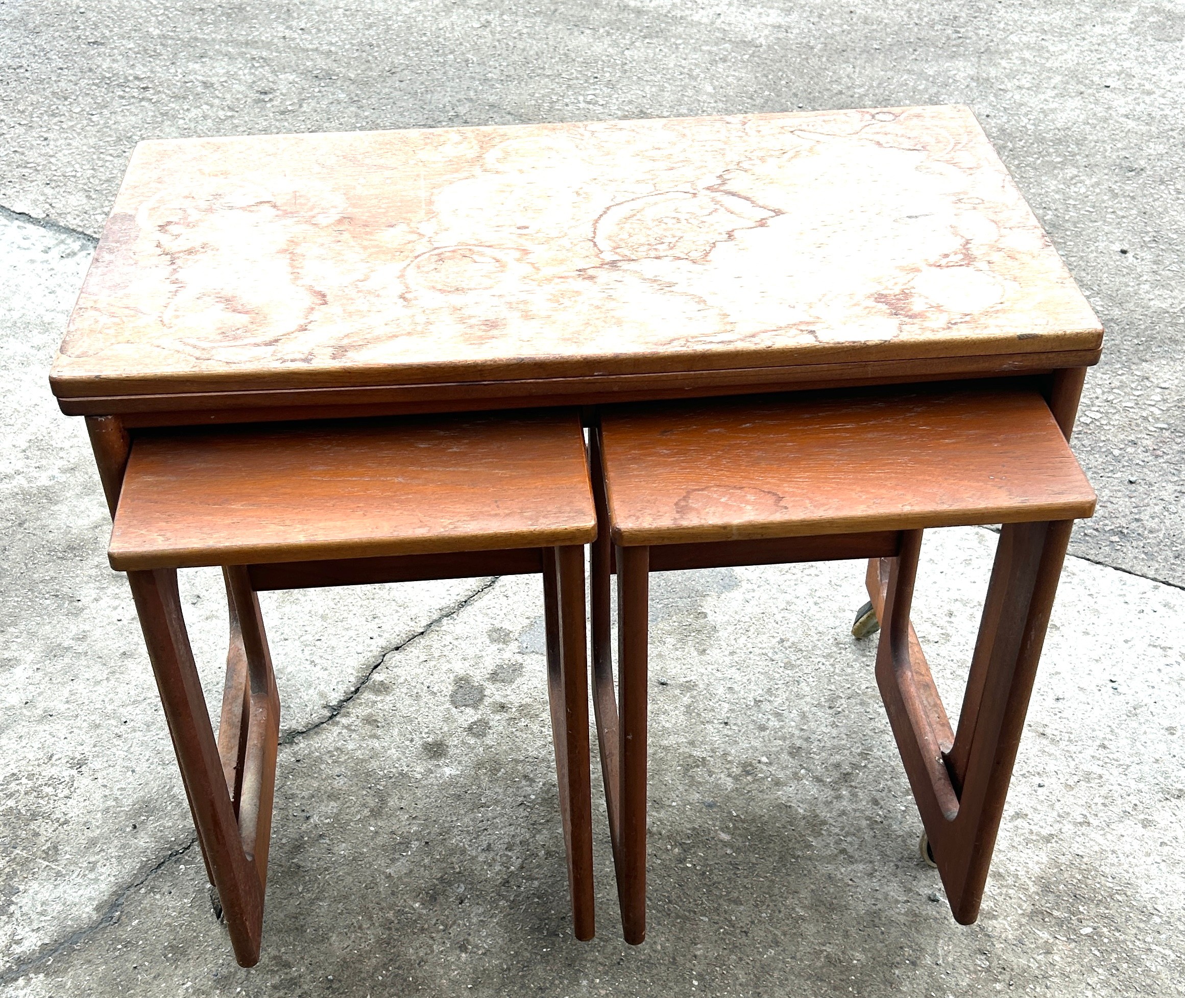 Teak nest of three tables in need of repair to top - water damaged