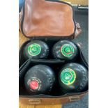 Set of four vintage lawn bowls to include Thomas Taylor and bag