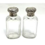 Pair of antique silver top scent bottles each measure approx 9cm hight in good condition london