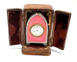 An extremely fine miniature silver and pink guilloche enamel carriage or travel clock in its