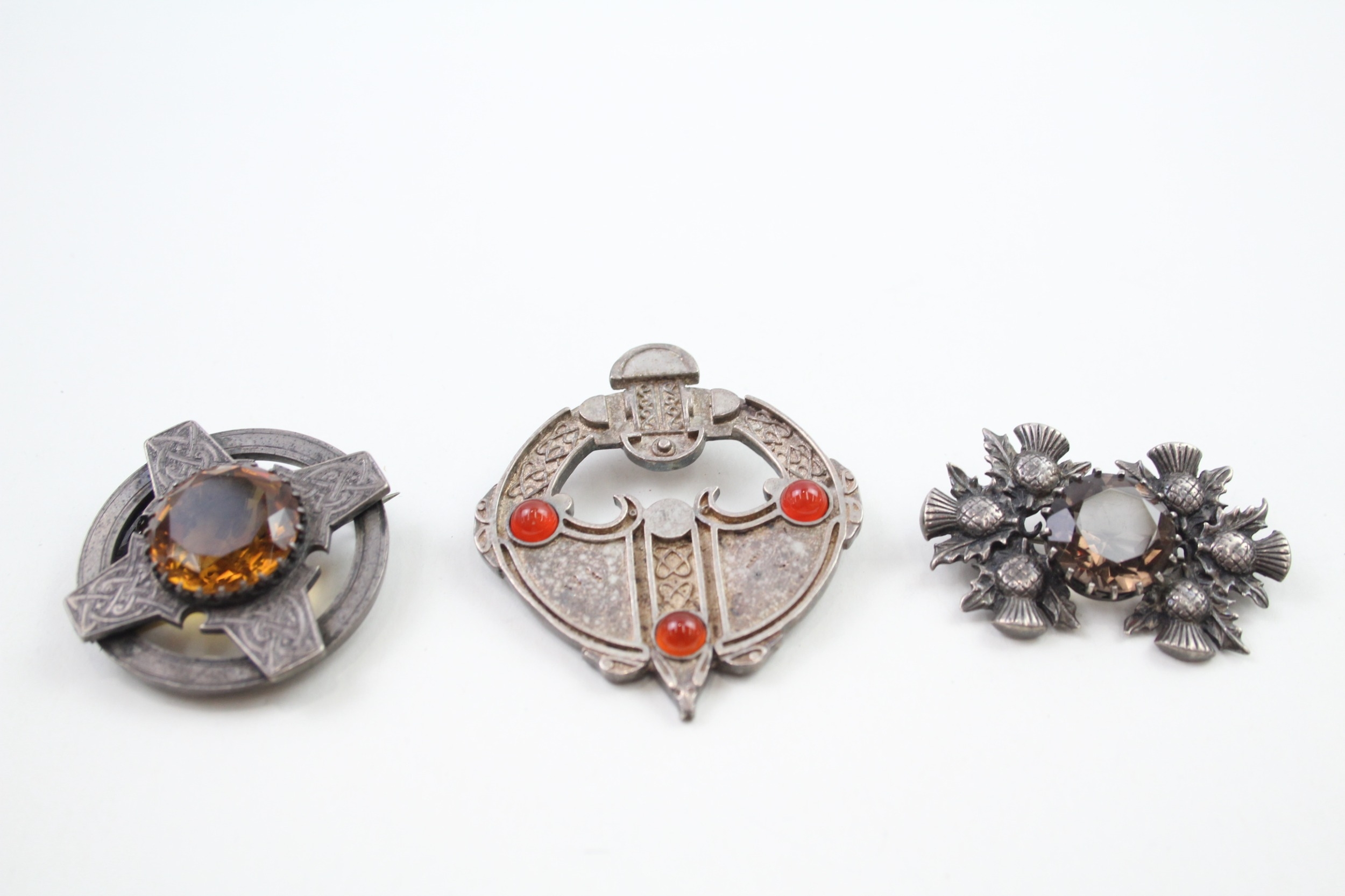 Three Scottish silver brooches including a Victorian example (65g)