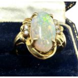 18ct gold large opal & diamond ring opal measures approx 16mm by 8mm with 3 diamons each side weight