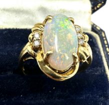 18ct gold large opal & diamond ring opal measures approx 16mm by 8mm with 3 diamons each side weight