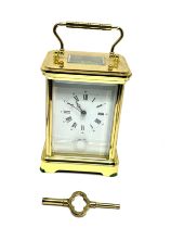 Large striking brass carriage clock measures approx 14cm high comes with key the clock is ticking