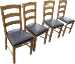 Set of four oak and faux leather dining chairs