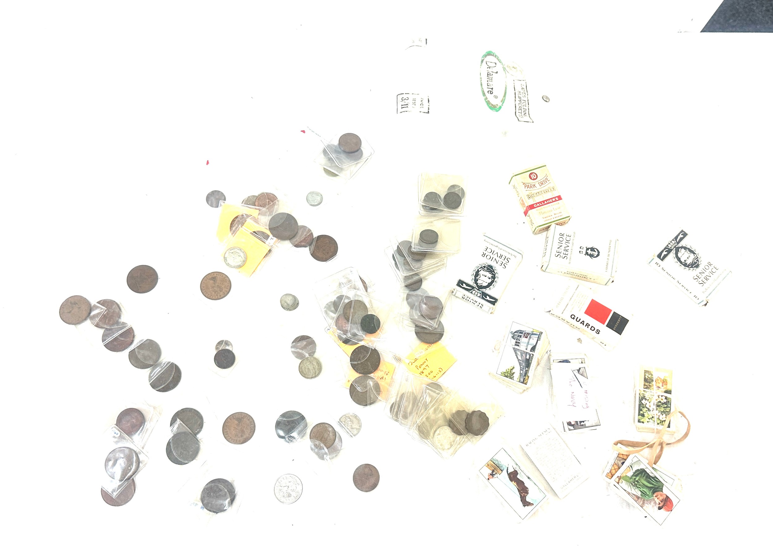 Quantity of vintage coins, pennies and foreign some silver along with a collection of cigarette