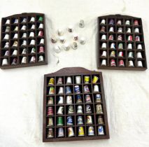 Selection of over a 100 advertising thimbles in wooden cases