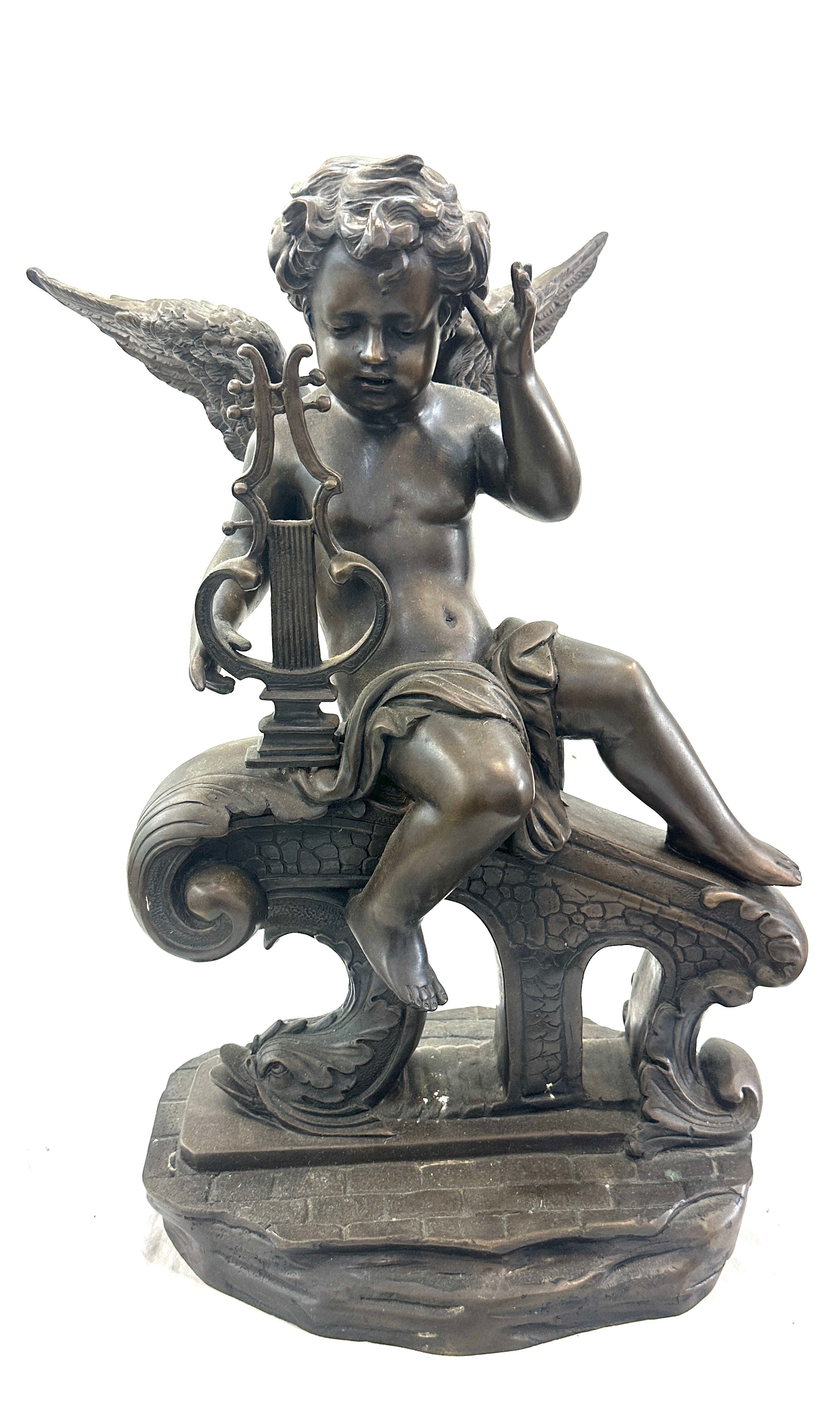 Vintage heavy Bronzed metal figure of a cherub measures approximately 12 inches wide 20 inches tall