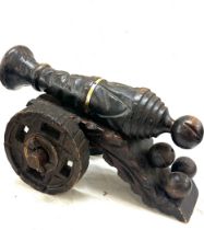 Carved wooden cannon figure measures approximately 10 inches tall §7 inches long