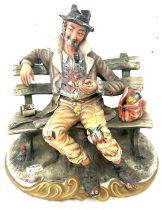 Signed Capodimonte homeless man on a bench figure measures approx 10 inches tall, 10 wide and 8 deep