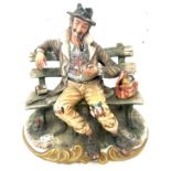 Signed Capodimonte homeless man on a bench figure measures approx 10 inches tall, 10 wide and 8 deep