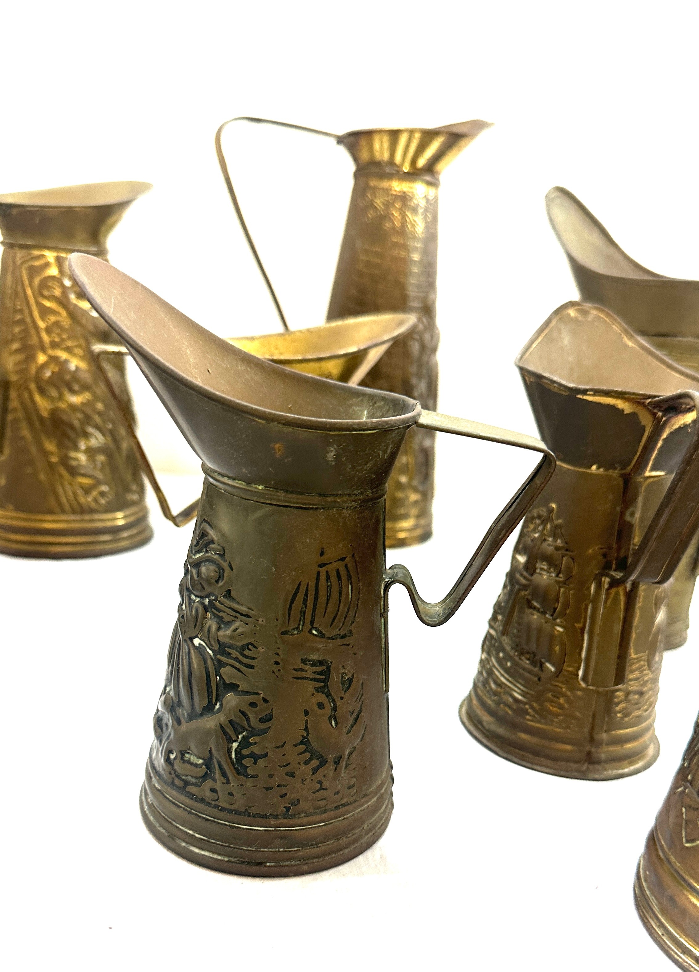 Selection embossed brass jugs, various heights - Image 4 of 6