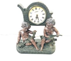Resin cherub Juliana mantel clock measures approx 15 inches tall by 15 inches wide and 7 deep