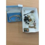 Selection of pearl necklaces costume jewellery and a silver spoon