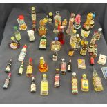 Selection of vintage alcohol miniatures includes Jager master, port, brandy etc