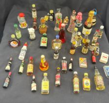 Selection of vintage alcohol miniatures includes Jager master, port, brandy etc