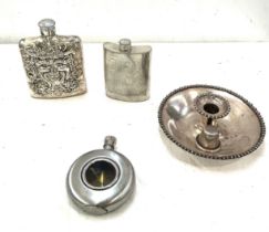 Selection of Hip flasks and a candle stick