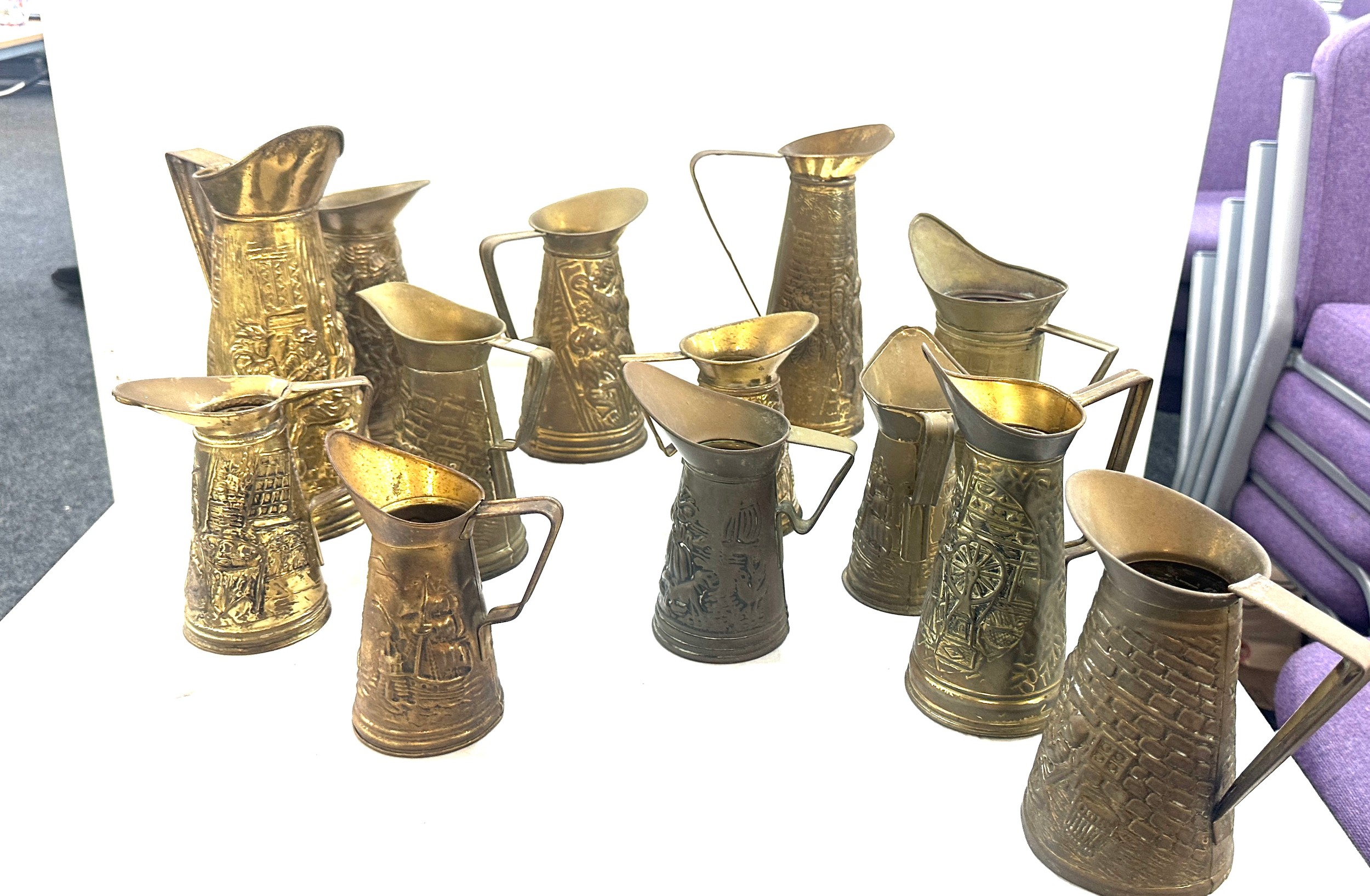 Selection embossed brass jugs, various heights