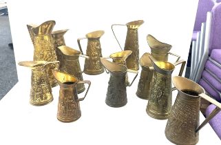 Selection embossed brass jugs, various heights
