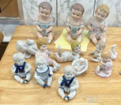 Large selection of assorted Baby figures includes Piano babies etc