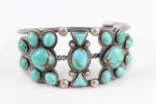 A silver Native American turquoise set bangle (60g)