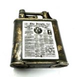 Silver lift arm cigarette lighter with the enamel the people news paper