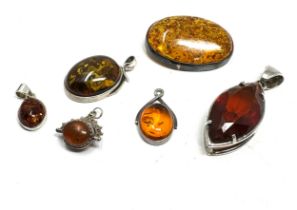 selection of silver & amber pendants & brooch & small swivel fob weight 43g