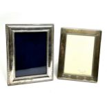 2 silver picture frames largest measures approx 18cm by 14cm