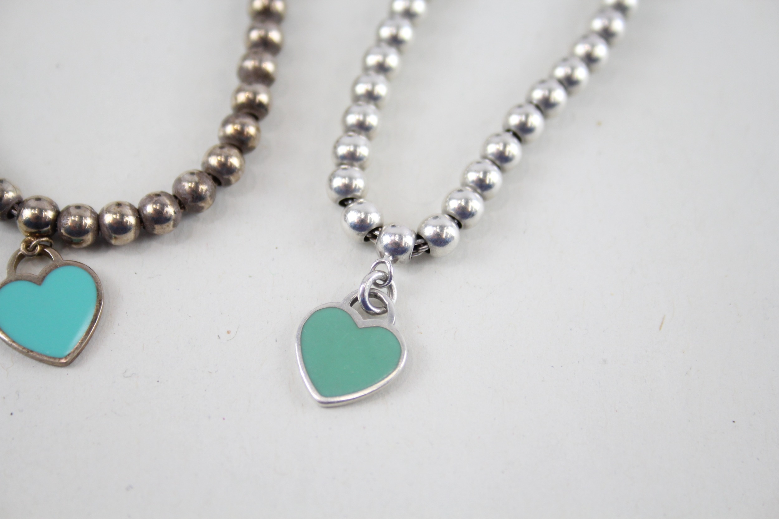 Two silver bracelets with enamel heart charms by designer Tiffany & Co (11g) - Image 3 of 7