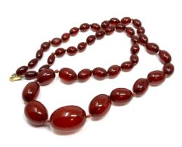 Antique cherry amber / bakelite bead necklace with internal streaking weight 60g 9ct gold clasp