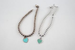 Two silver bracelets with enamel heart charms by designer Tiffany & Co (11g)