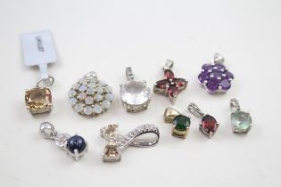 A collection of silver TGGC gemstone pendants including Opal (21g)