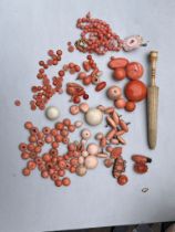 Assorted antique coral beads buttons etc weight 75g also includes bone umbrella needle case