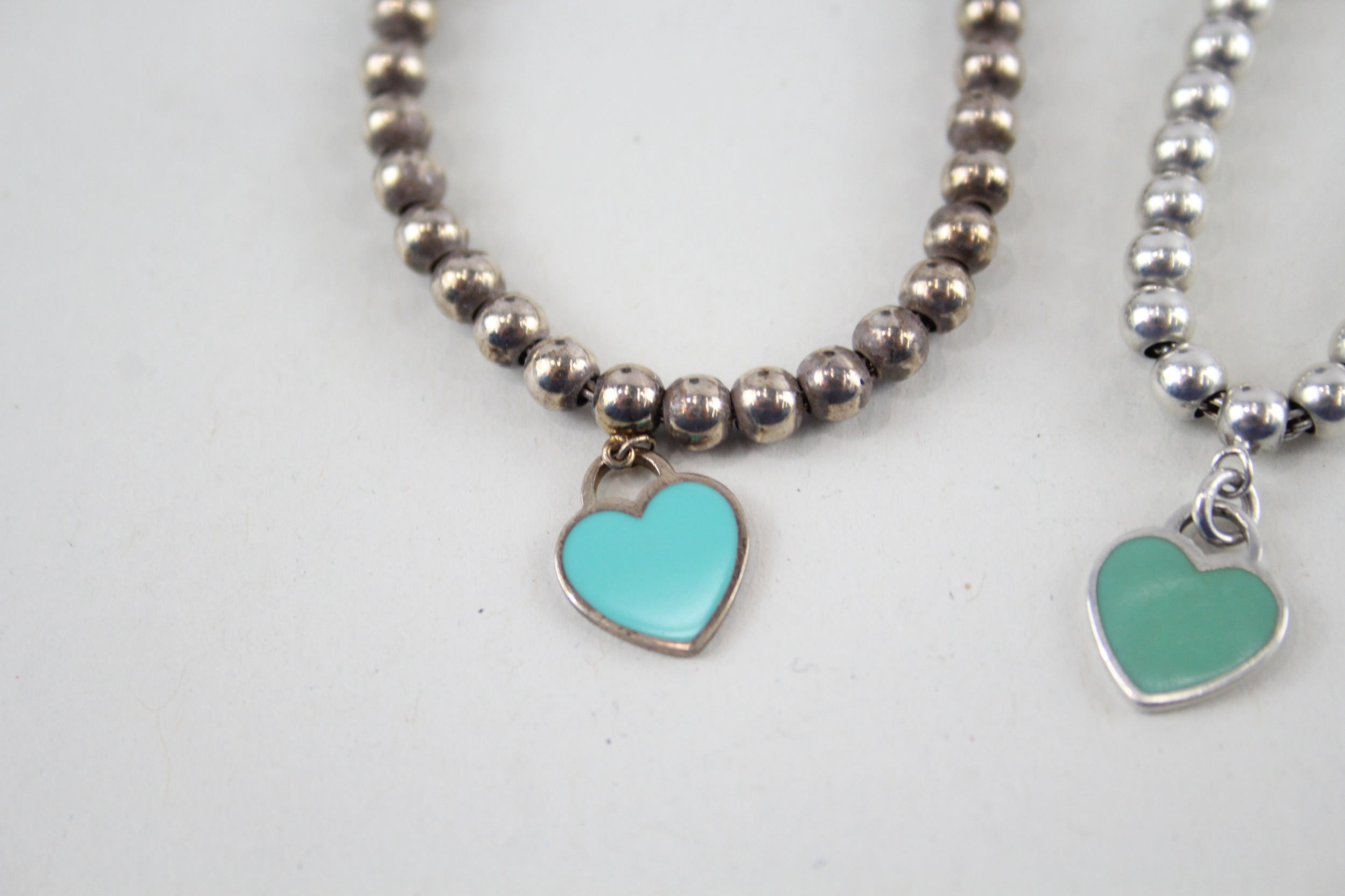 Two silver bracelets with enamel heart charms by designer Tiffany & Co (11g) - Image 2 of 7