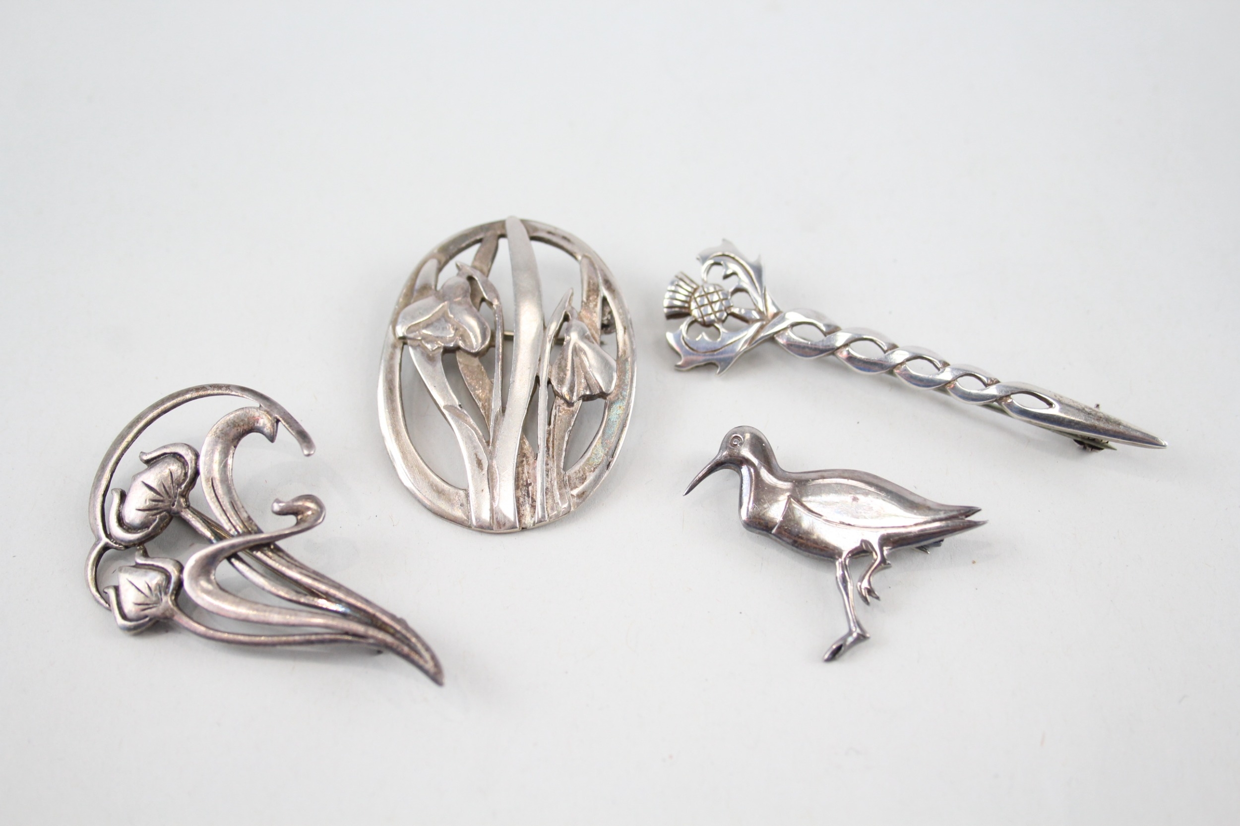 Four silver Scottish/Celtic brooches including Ola Gorie & Malcolm Gray (23g)