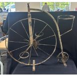 Metal penny farthing planter measures approximately 30 inches tall