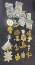 Large selection of assorted cap badges