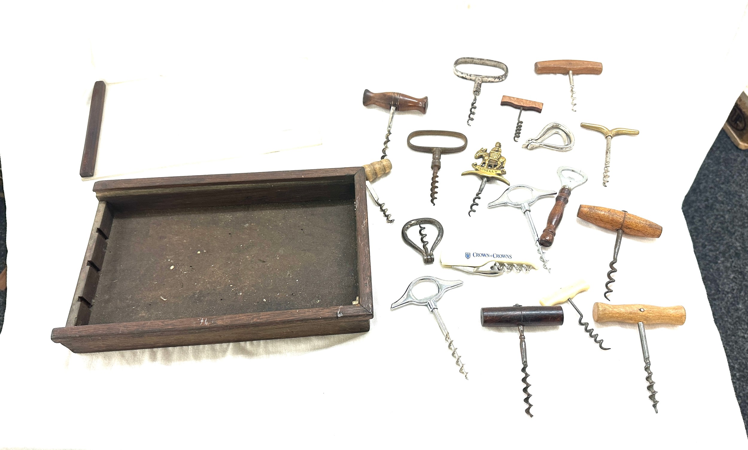 Selection of vintage and later cork screws in a display case/ drawer