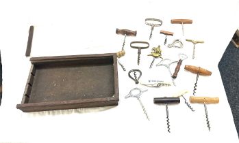 Selection of vintage and later cork screws in a display case/ drawer