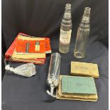 Box of automabilia includes glass bottles, car books etc